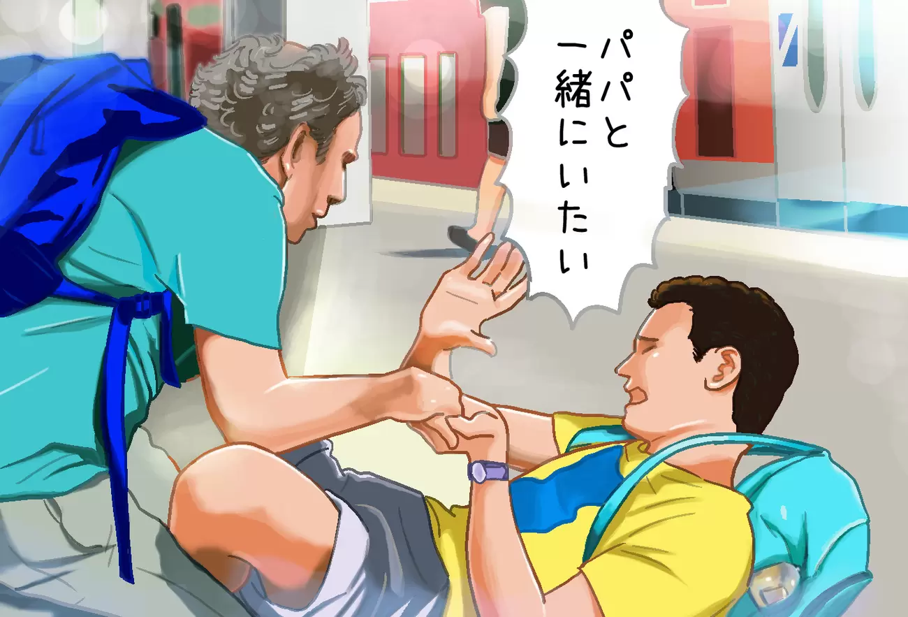 電車のホームでパニックになる息子となだめる父親